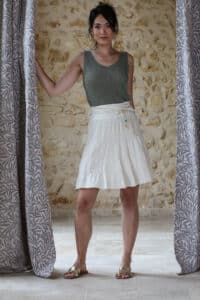 Shooting model wearing ecru bohemian short skirt with khaki lurex top