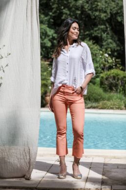 Oversize white plain blouse shoot with orange bootcut jeans