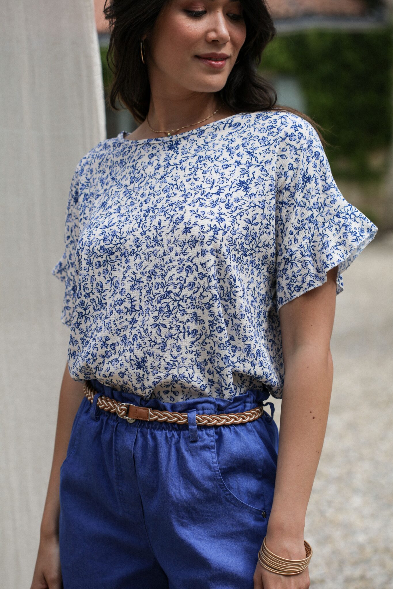 Shooting model wearing current blouse printed pinks blue sleeves short sleeves