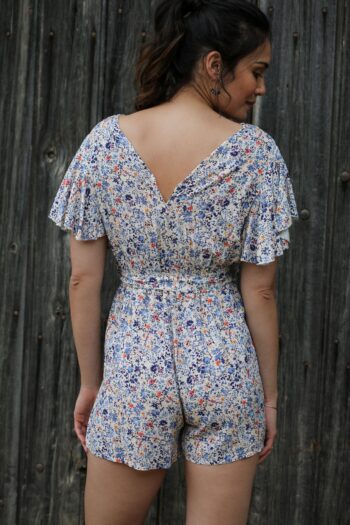 Shooting model wearing our floral jumpsuit Butterfly sleeves blue jeans current back