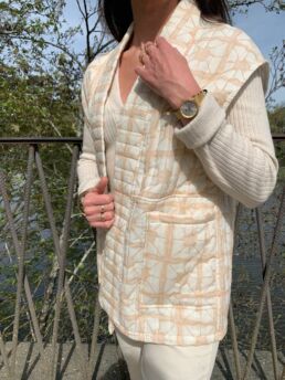 beige sleeveless jacket with patterns