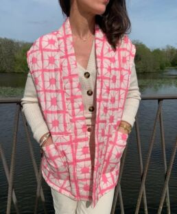 Pink sleeveless quilted jacket from the front