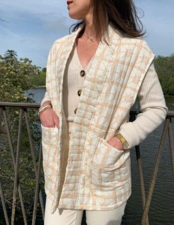 beige sleeveless jacket with patterns and pockets