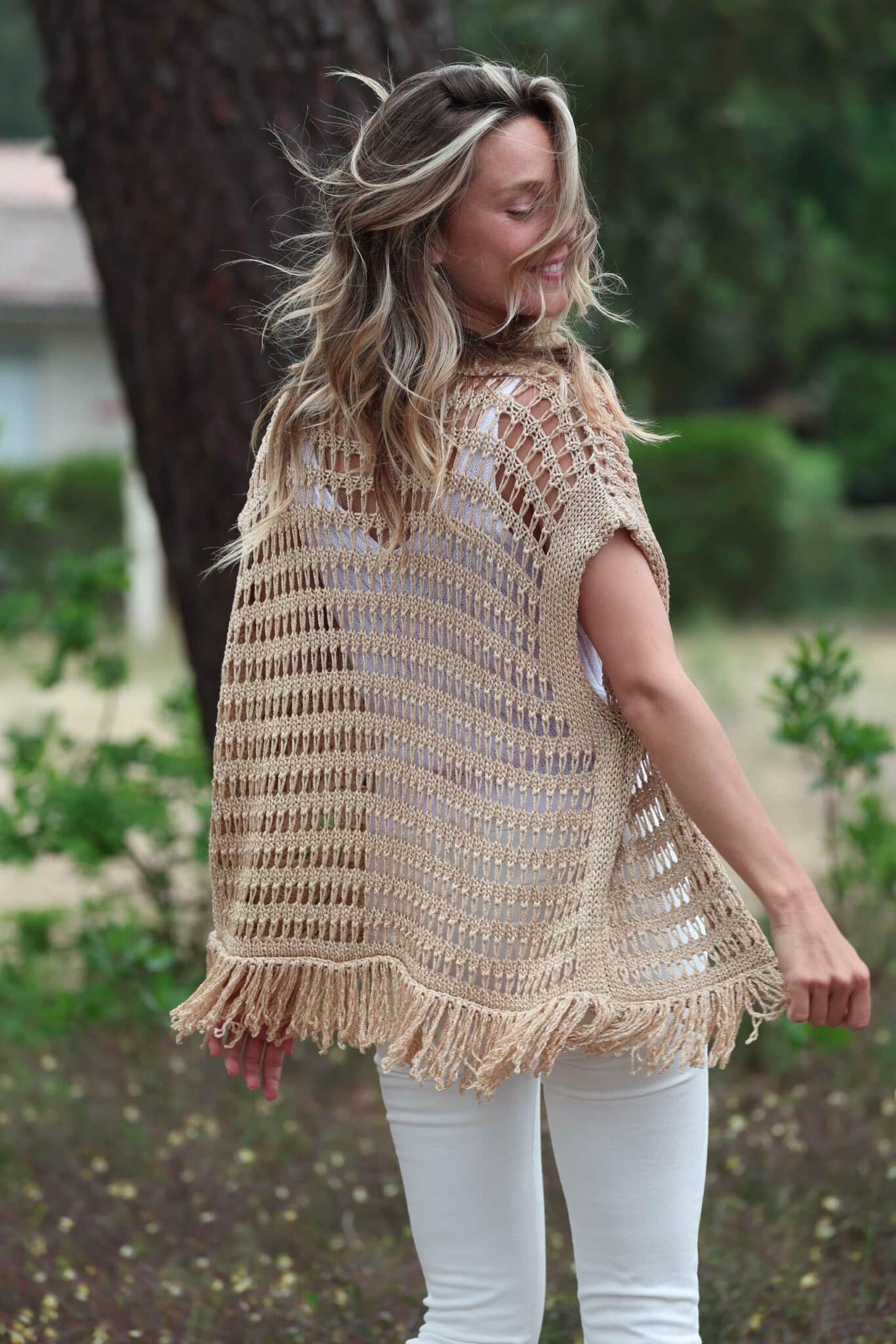 Golden vest with back fringes with hair in the wind