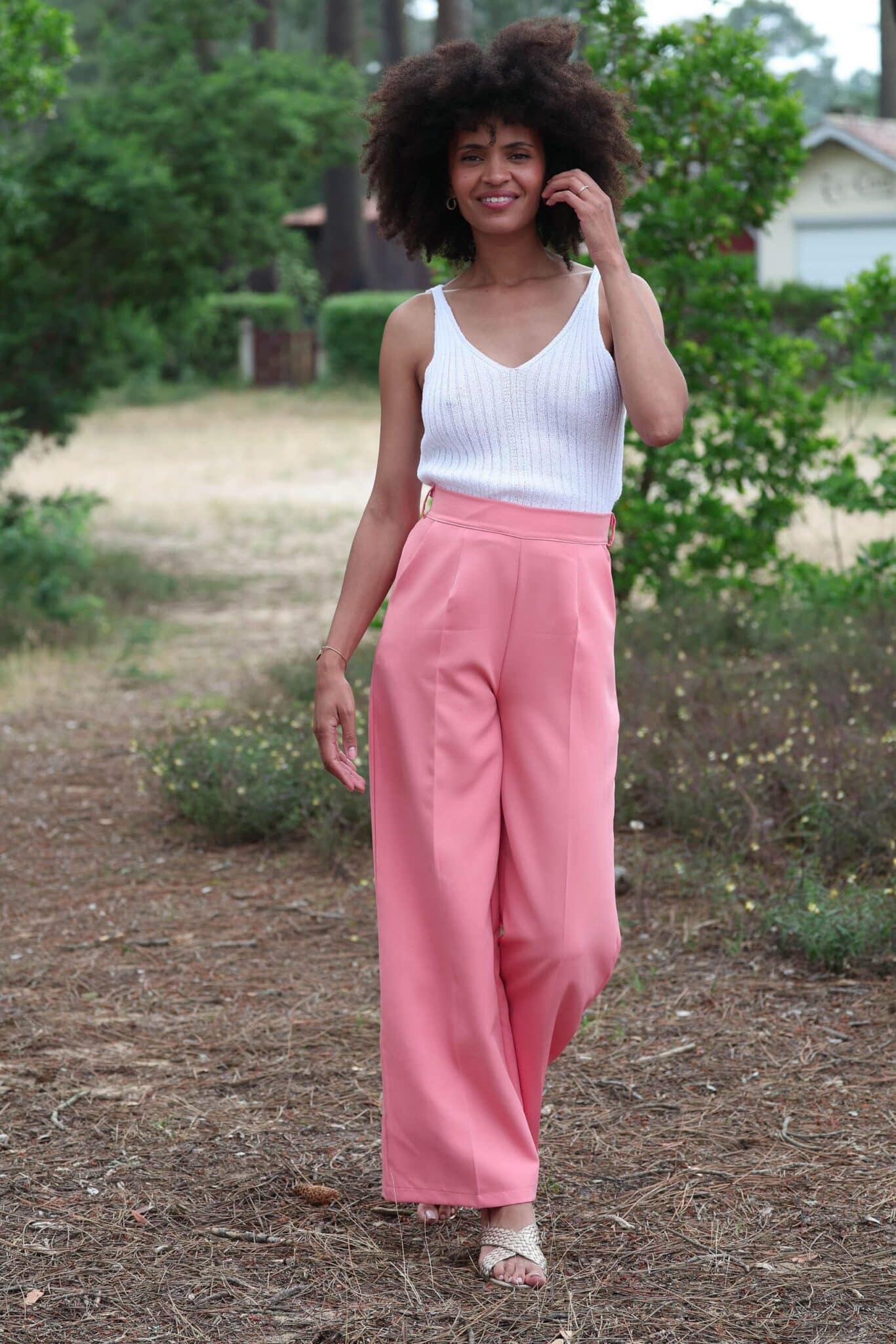 Pink Palazzo pants with white knitted top in the middle of nature 2